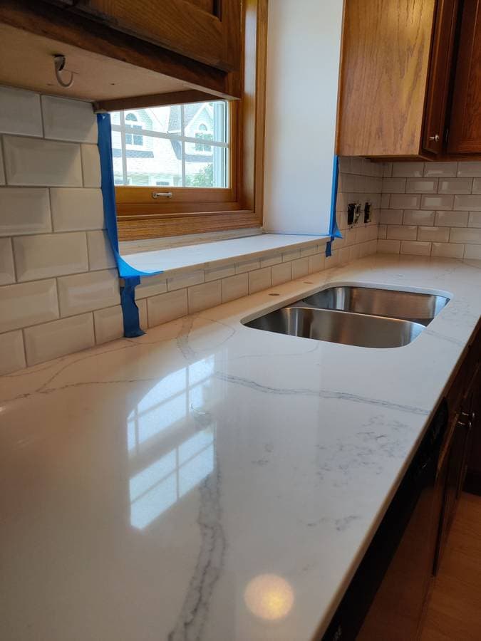 picture of a newly installed granite kitchen countertop with a stainless steel dual kitchen sink
