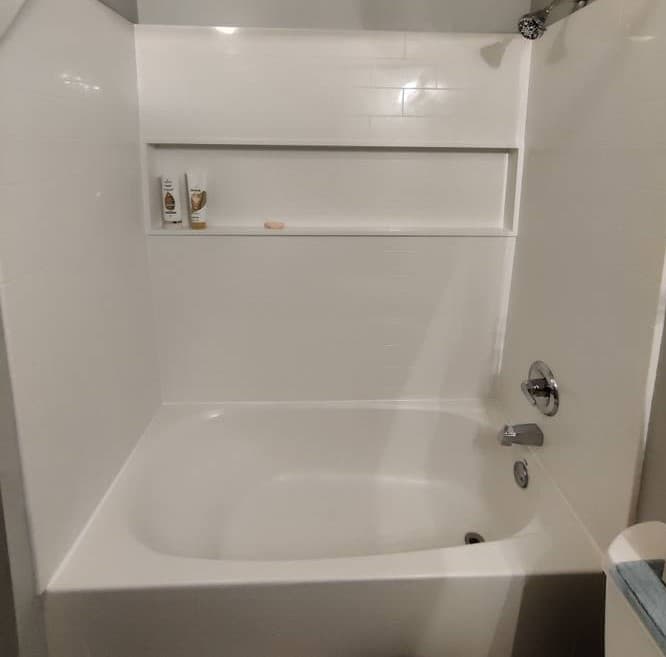 picture of a remodeled and newly installed bathroom shower and bathtub